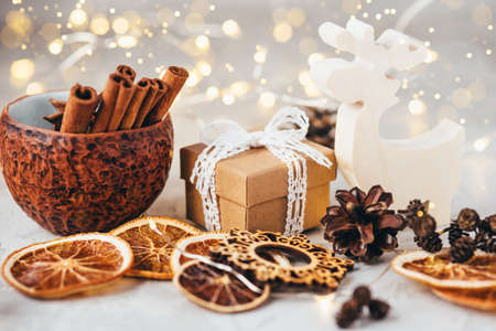 The figure of the reindeer, gift box, dry oranges and pine cone. Christmas decor, winter mood, holiday decoration.の写真素材