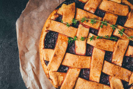 Freshly baked homemade pie with berries on a black background.の写真素材