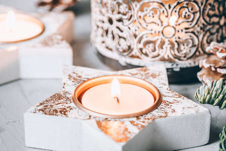 Christmas decorations: candlesticks, fir branches and a garland on a gray background.の写真素材