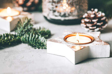Christmas decorations: candlesticks, fir branches and a garland on a gray background.の写真素材