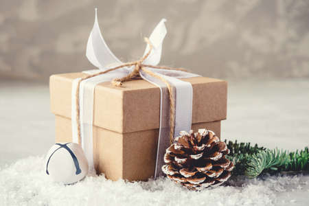 Christmas gifr box in the snow on gray background. Christmas decor, winter mood, holiday decoration.の写真素材