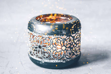 Beautiful Christmas candlestick with sparks on a gray background.の写真素材