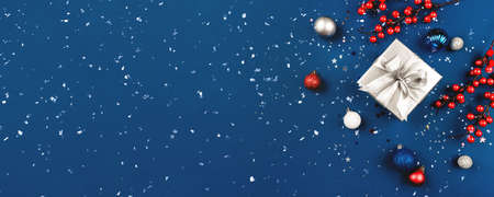 Blue Christmas background of gift box and decorations. The concept of the winter holidays. Flat lay, top view, copy space.の写真素材