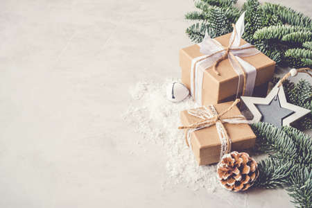 Christmas gift box in the snow on gray background. Christmas decor, winter mood, holiday decoration.の写真素材