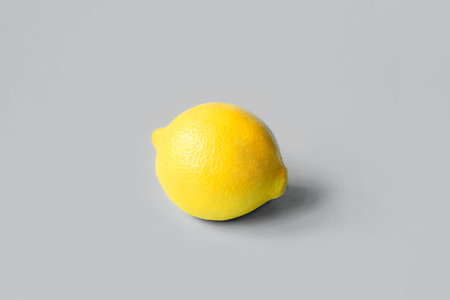 Ripe lemon on a gray background. Colors 2021.の写真素材
