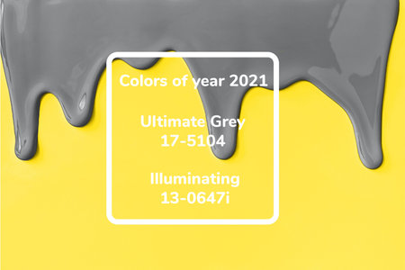 Gray paint leaking down yellow background. Colors 2021.の写真素材