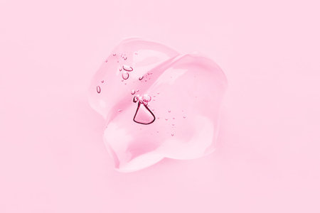 Transparent gel texture on a pink background.の写真素材