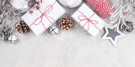 Festive Christmas background with white gift boxes and Christmas decorations.の写真素材