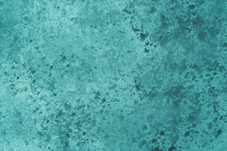Abstract turquoise background with concrete texture and spots.の写真素材