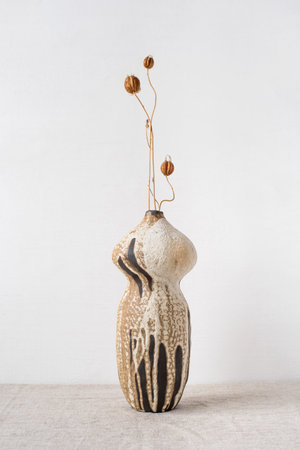 Handmade ceramics in the style of wabi sabi. Brown clay vase with an abstract pattern.の写真素材