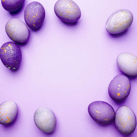Easter frame of eggs painted in purple color. Flat lay, top view. Copy space for text.の写真素材