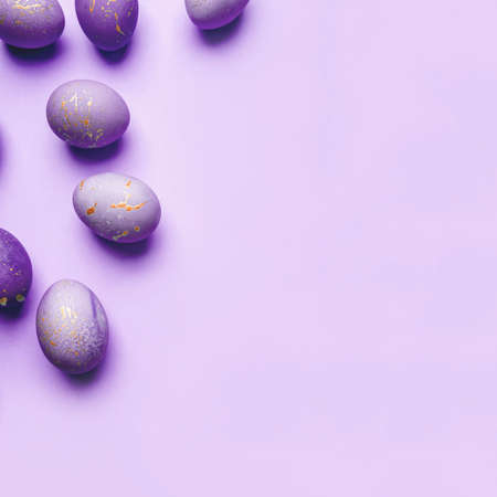 Easter frame of eggs painted in purple color. Flat lay, top view. Copy space for text.の写真素材