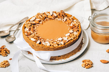 Cheesecake with salted caramel and nuts on a gray background.の写真素材
