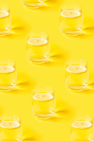 Summer pattern with glasses of lemonade on yellow background.の写真素材