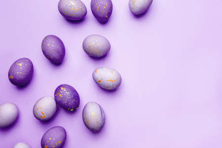 Easter frame of eggs painted in purple color. Flat lay, top view. Copy space for text.の写真素材