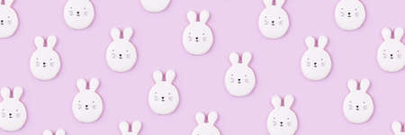 Pattern of Easter bunny cookies on lilac background. Spring holiday.の写真素材