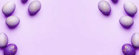 Easter frame of eggs painted in purple color. Flat lay, top view. Copy space for text.の写真素材