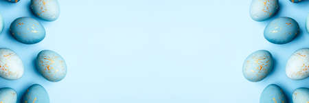 Easter frame of eggs painted in blue color. Flat lay, top view. Copy space for text.の写真素材