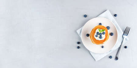 A stack of pancakes with fresh blueberries and cheesecream. Top view.の写真素材