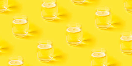Summer pattern with glasses of lemonade on yellow background.の写真素材