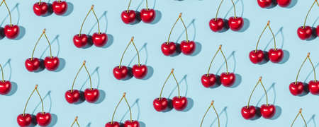 A ripe cherry berries on a blue background. Flat lay, top view.の写真素材