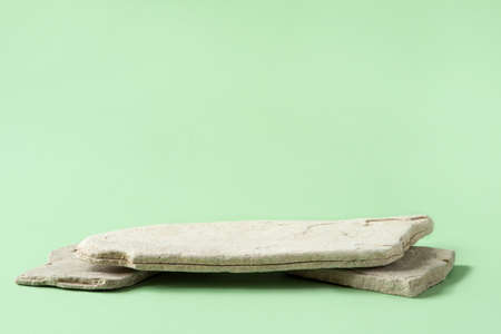 Background for cosmetic products of natural beige color. Stone podium on a green background. Front...