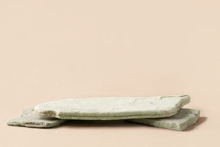 Background for cosmetic products of natural beige color. Stone podium on a pink background. Front view.の写真素材