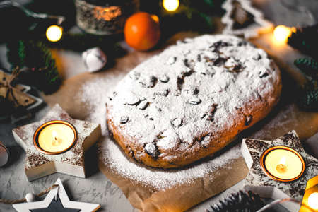 Traditional german stollen cake with Christmas decorations on the table.の写真素材