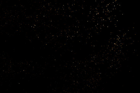 Golden abstract bokeh on black background.の写真素材