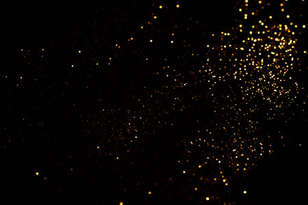 Golden abstract bokeh on black background.の写真素材