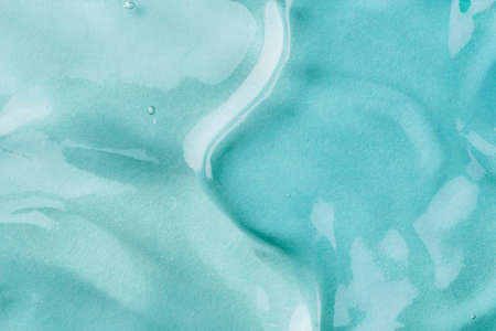 Transparent hyaluronic acid gel on a blue background.の写真素材