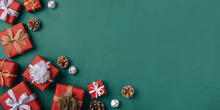 Gift boxes with white and brown bows on a green backdrop.の写真素材