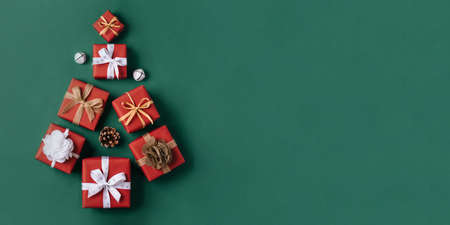 Gift boxes with white and brown bows on a green backdrop.の写真素材