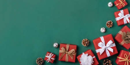 Gift boxes with white and brown bows on a green backdrop.の写真素材