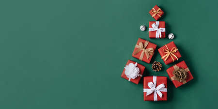 Gift boxes with white and brown bows on a green backdrop.の写真素材