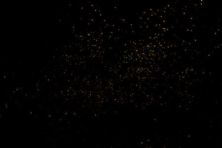 Golden abstract bokeh on black background.の写真素材