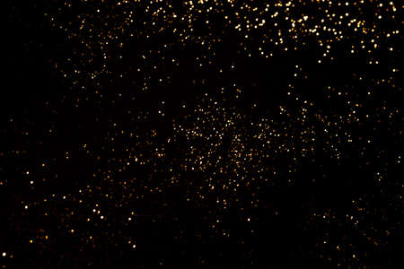 Golden abstract bokeh on black background.の写真素材