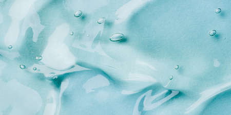 Transparent hyaluronic acid gel on a blue background.の写真素材
