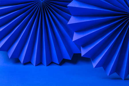 Minimalistic background made of blue paper.の写真素材