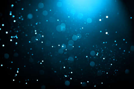 Abstract background with glowing turquoise particles.の写真素材