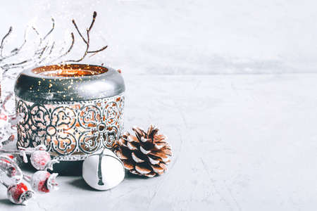 A composition of candlestick, snow branches and Christmas decorations.の写真素材