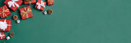 Gift boxes with white and brown bows on a green backdrop.の写真素材
