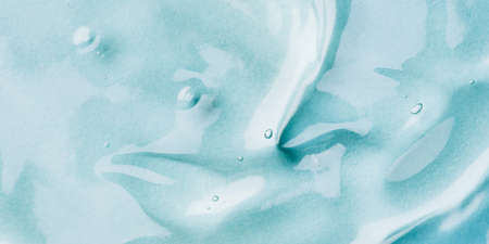 Transparent hyaluronic acid gel on a blue background.の写真素材