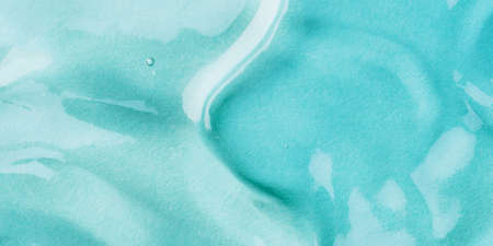 Transparent hyaluronic acid gel on a blue background.の写真素材