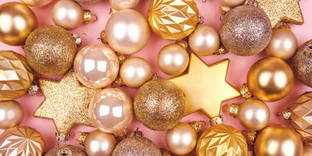 Festive pink background with gold and silver Christmas balls.の写真素材