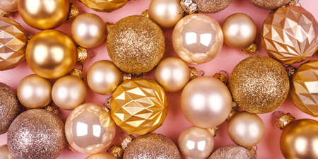 Festive pink background with gold and silver Christmas balls.の写真素材