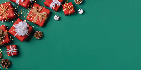 Gift boxes with white and brown bows on a green backdrop.の写真素材