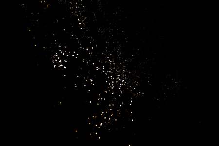 Golden abstract bokeh on black background.の写真素材