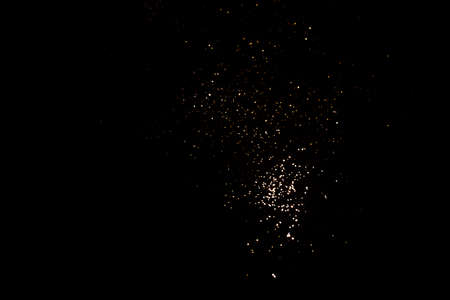 Golden abstract bokeh on black background.の写真素材