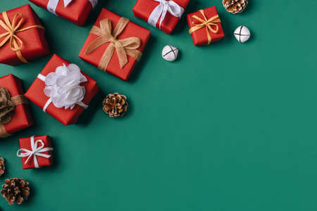 Gift boxes with white and brown bows on a green backdrop.の写真素材